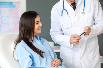 Male gynecologist working with woman in clinic