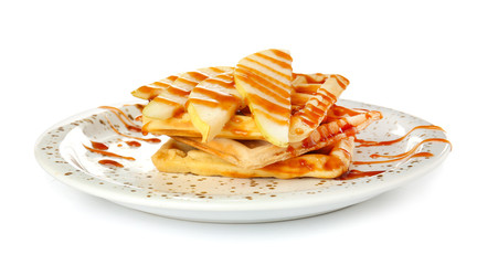 Plate with tasty waffles and pears on white background