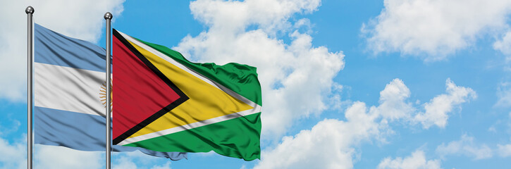 Argentina and Guyana flag waving in the wind against white cloudy blue sky together. Diplomacy concept, international relations.