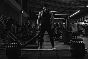 Young man powerlifter preparing for deadlift