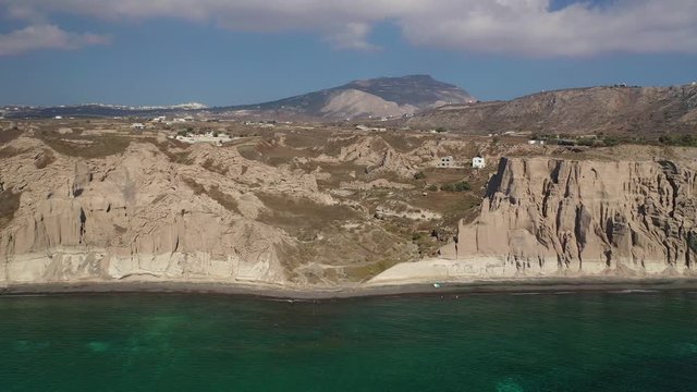 Aerial drone video of amazing shape giant volcanic rock formations in Vlychada beach, Santorini island, Cyclades, Greece