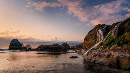 Sunset Waterfall Cascade at the Pacific Ocean