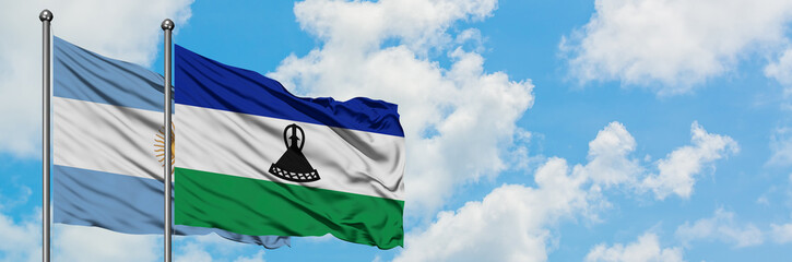 Argentina and Lesotho flag waving in the wind against white cloudy blue sky together. Diplomacy concept, international relations.