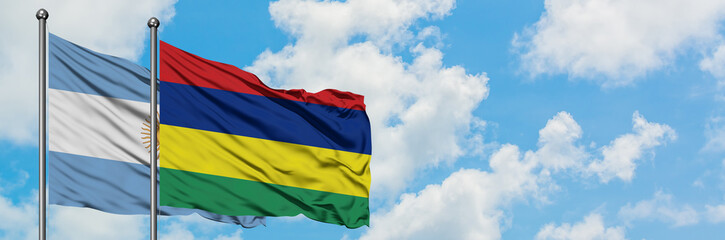 Argentina and Mauritius flag waving in the wind against white cloudy blue sky together. Diplomacy concept, international relations.