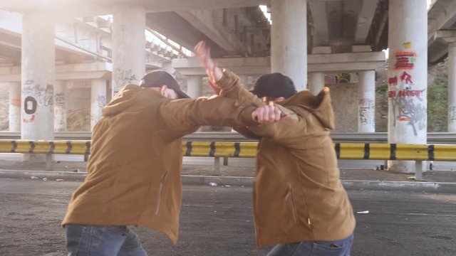 Two men have fight under bridge