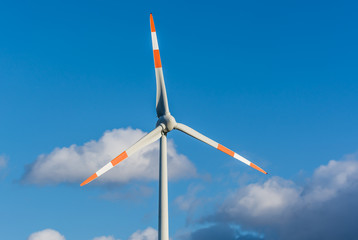 Wind turbine against blue sky