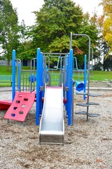 Fototapeta na wymiar Playground slides on cold fall day