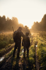 father pointing and guiding son on first deer hunt - 297435100