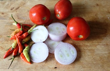 tomatoes and garlic on wooden board