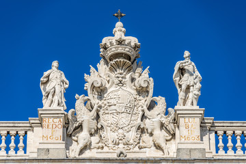 Fototapeta na wymiar Madrid Royal Palace (Palacio Real) Top East facade. Recaredo and Ervigio visigoth kins. Coat of arms of Phillip V, with the collars of the Orders of the Golden Fleece and of the Holy Spirit.