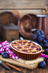 Fresh homemade dimply plum cake on rustic background
