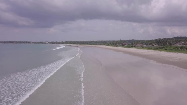 Aerial shot of the beaches of Philippines with long waves and white sand.