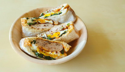 A Bowl of Homemade Sausage and Fried Egg Sandwiches  
