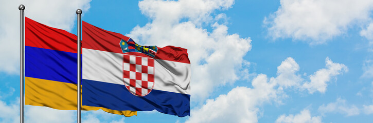 Armenia and Croatia flag waving in the wind against white cloudy blue sky together. Diplomacy concept, international relations.