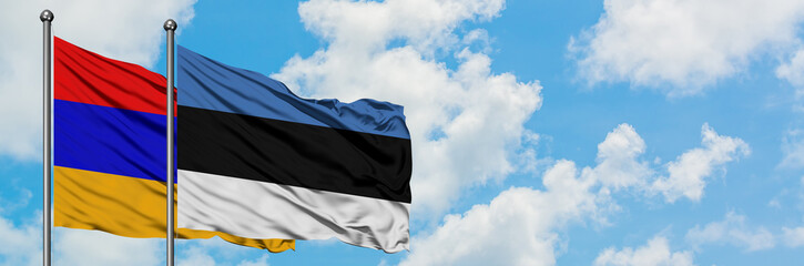 Armenia and Estonia flag waving in the wind against white cloudy blue sky together. Diplomacy concept, international relations.