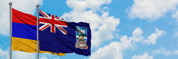Armenia and Falkland Islands flag waving in the wind against white cloudy blue sky together. Diplomacy concept, international relations.