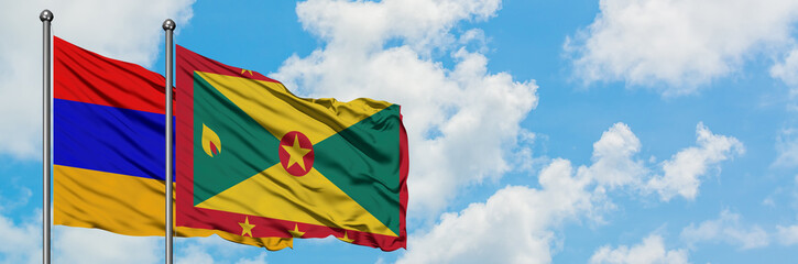 Armenia and Grenada flag waving in the wind against white cloudy blue sky together. Diplomacy concept, international relations.