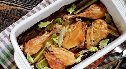 baked chicken pieces with celery stalk. chicken with celery. top view. copy space. keto recipe, low carb