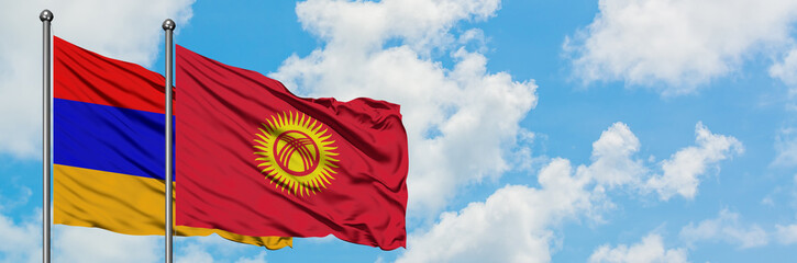 Armenia and Kyrgyzstan flag waving in the wind against white cloudy blue sky together. Diplomacy concept, international relations.