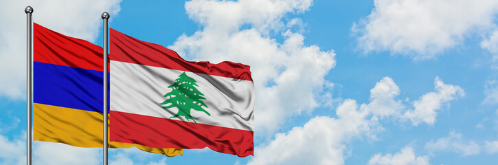 Armenia and Lebanon flag waving in the wind against white cloudy blue sky together. Diplomacy concept, international relations.