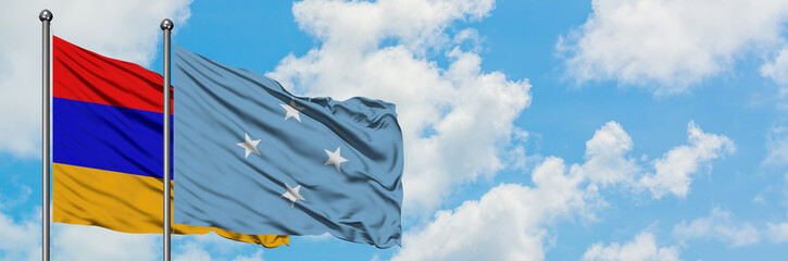 Armenia and Micronesia flag waving in the wind against white cloudy blue sky together. Diplomacy concept, international relations.