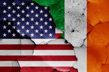 flags of USA and Ireland painted on cracked wall