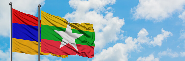 Armenia and Myanmar flag waving in the wind against white cloudy blue sky together. Diplomacy concept, international relations.