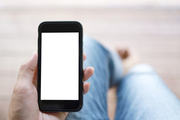 hand holding black smart phone with white screen.