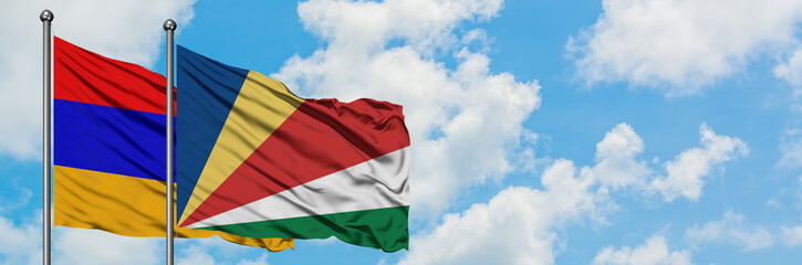 Armenia and Seychelles flag waving in the wind against white cloudy blue sky together. Diplomacy concept, international relations.