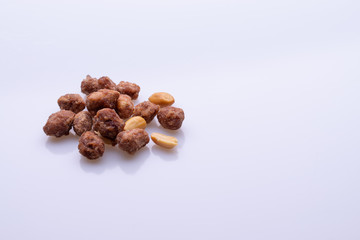 Peanuts praline sweet on dark grey background, top view, soft light, copy space