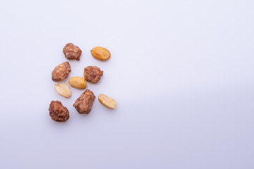 Peanuts praline sweet on dark grey background, top view, soft light, copy space