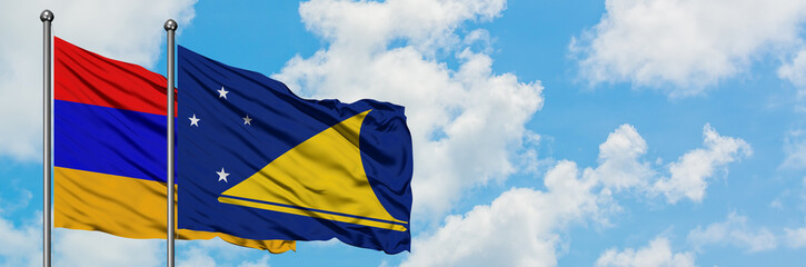 Armenia and Tokelau flag waving in the wind against white cloudy blue sky together. Diplomacy concept, international relations.