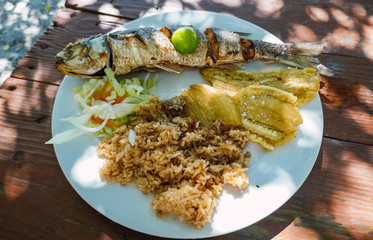 Enjoy a picnic on the beach with fried fish and coconut rice, Caribbean, Colombia. Colombian cuisine