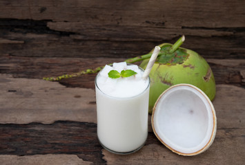 Coconut smoothies white fruit juice milkshake blend beverage healthy high protein the taste yummy In glass drink episode morning on a wooden 