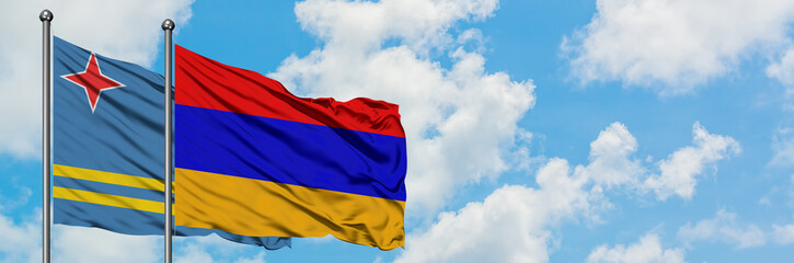 Aruba and Armenia flag waving in the wind against white cloudy blue sky together. Diplomacy concept, international relations.