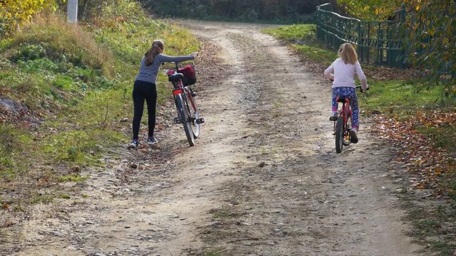 Slow motion cute girls having ride together in rural landscape FullHD 180p
