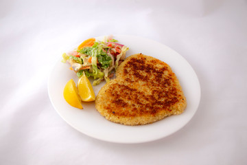 Heart shape Chicken Schnitzel with salad and wedges