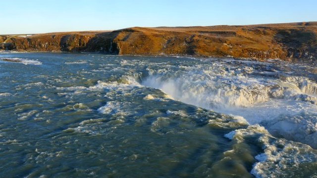 Aerial view of frozen Urriðafoss waterfall in Iceland with wild river