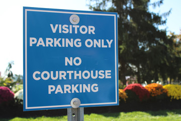 Visitor parking street signs in US and Canada in English and French.Warm autumn on the street.