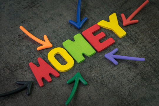 Money, Financial Vehicle Or Investment Asset Concept, Multi Color Arrows Pointing To The Word Money At The Center Of Black Cement Chalkboard Wall