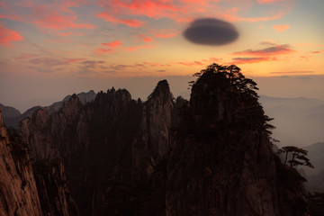 Huangshan Sunrise, China National Park - Anhui Province, Chinese Mountain Peak Silhouettes. Yellow Granite Mountains with Canyon, Exotic Pine Trees, Jagged Cliffs, UNESCO World Heritage Site