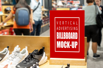 Mock up vertical signboard on showcase of shoes