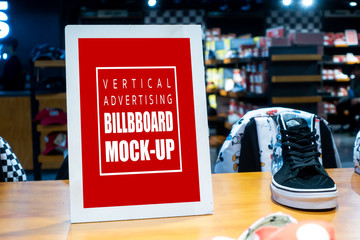 Mock up vertical signboard on showcase of shoes