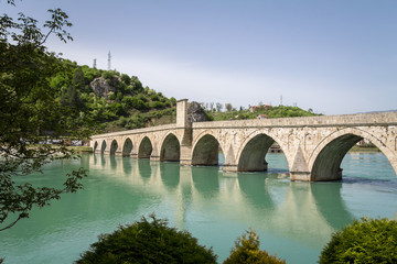 Fototapeta na wymiar Mehmed Pasa Sokolovic bridge in spring. Also called Drina bridge, or Most na Drini, it is a medieval ottoman architecture bridge on Drina river