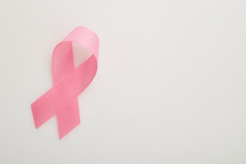 Pink breast cancer ribbon on white
