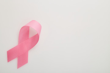 Pink breast cancer ribbon on white