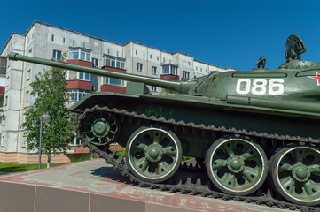 Soviet caterpillar tank T 54 in a green color. Monument. Side view.