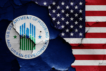 flags of Department of Housing and Urban Development and USA painted on cracked wall