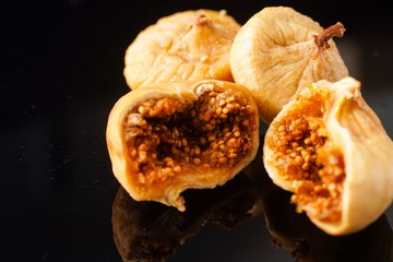 Dried figs isolated against black