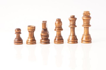 wooden chess pieces isolated against white